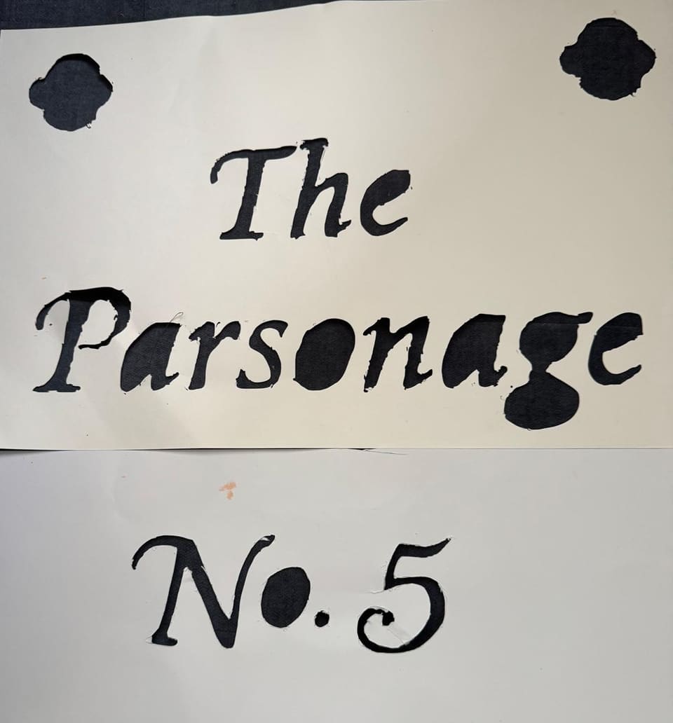 Two white paper stencils on dark cloth, one cut with The Parsonage and two corner motifs, the other cut with No. 5.