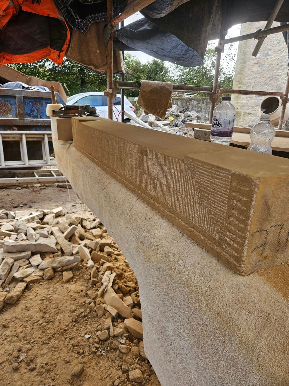 Close view along the sandstone sill on the banker, its wash and face broached and tooled.