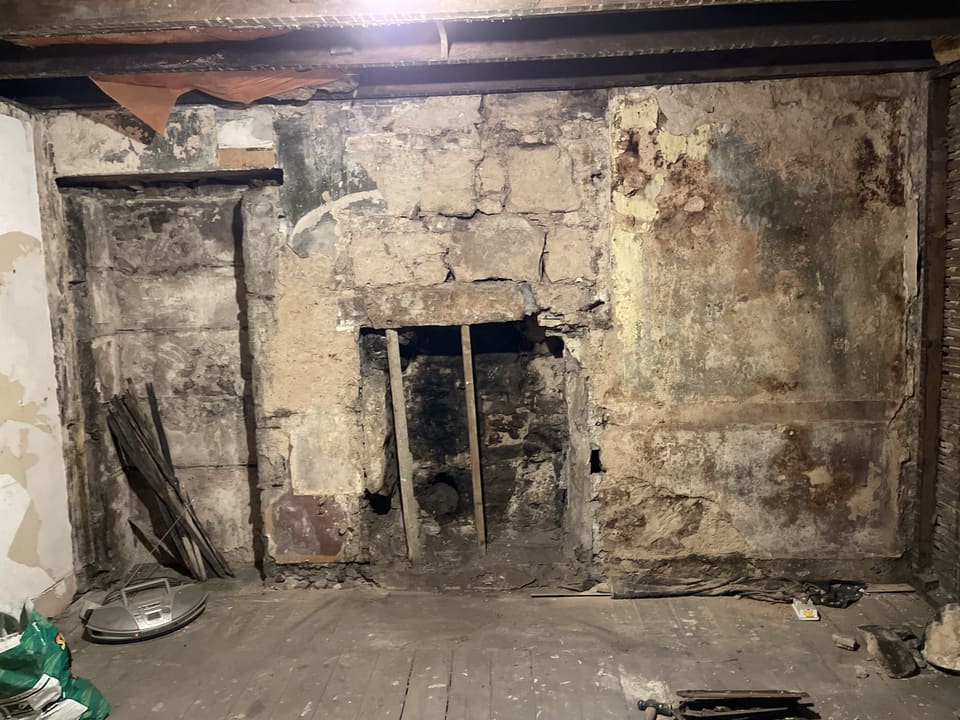 Stone Fireplace and Exposed Wall - before